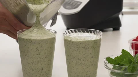 Serving Chia seeds celery spinach banana smoothie in glasses. Stock Footage 150893177