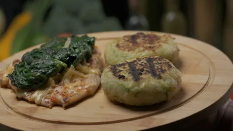 Serving chicken steak with veggies on the round board Stock Footage 140646507