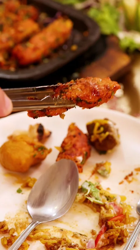 Serving Chicken Tikka and Indian Cuisine at a Restaurant Table Stock Footage 340191122