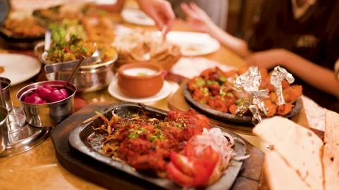 Serving Chicken Tikka and Indian Cuisine at a Restaurant Table Stock Footage 344939933