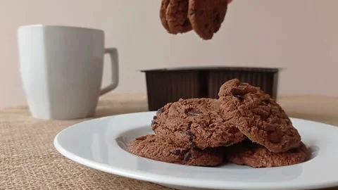 Serving the chocolate biscuits on the white plate Stock Footage 150398734