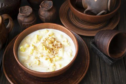 A serving of clam chowder in an old bowl, traditional milk soup of Belarus Stock Photos