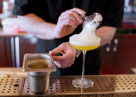 Serving cocktail mixologist work bartender frothy Stock Photos