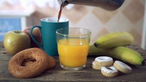 Serving coffee in a ceramic mug with a glass of orange juice Stock Footage 102098358