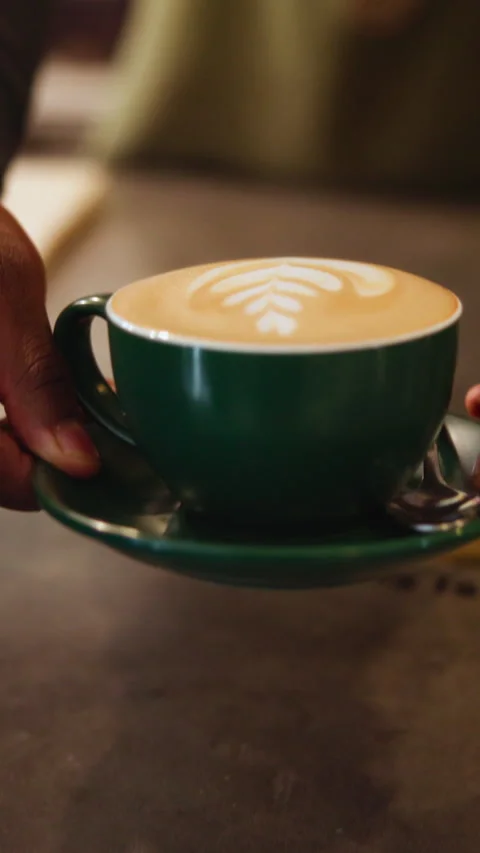 Serving, coffee shop and hands of woman with cappuccino, drink and beverage for Stock Footage 337470334