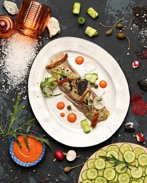 Serving cold meat cuts. Platter with festive Appetizer on gray table background Stock Photos