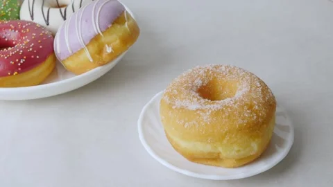 Serving colorful icing glazed Donuts. Stock Footage 312038006