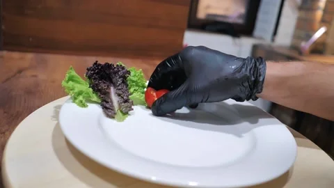 Before serving. the cook decorates the dish with vegetables before serving Stock Footage 221118791
