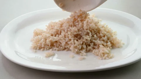 Serving cooked brown rice Stockbeeldmateriaal 227103239