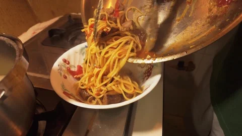 Serving Cooked Spaghetti with Tomato Sauce and Beef into a Bowl Stock Footage 344670313