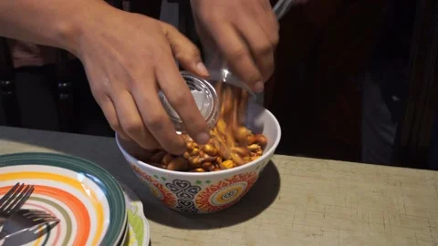 Serving corn nut from several disposable cups in a plastic container brought Stock Footage 154812840