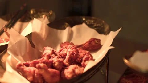 Serving Crispy Fried Chicken Wings from Buffet Tray with Metal Tongs Stock-Footage 340191037