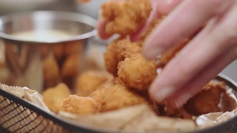 Serving of crispy golden fried chicken nuggets, slow motion. Stock Footage 154328925