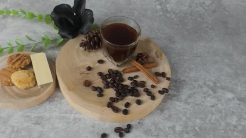 Serving Dark Drink with Beans and Cinnamon on Round Wood Slab Still Life Stock Footage 313251017