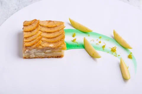 Serving of delicious fruit vanilla cake on a white plate Foto stock