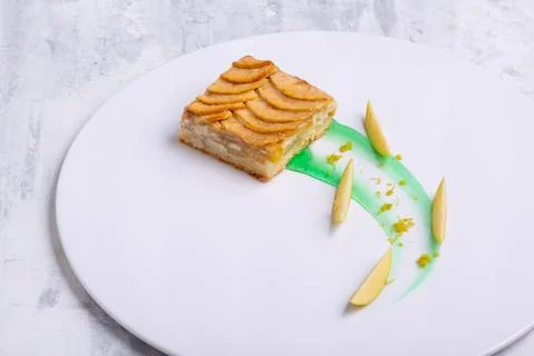 Serving of delicious fruit vanilla cake on a white plate Foto stock