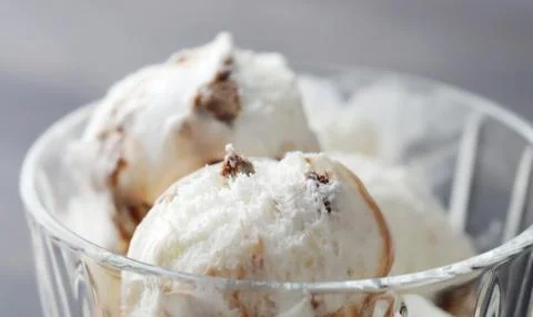 Serving Delicious Scoops Of Ice Cream Into A Glass Ice Cream Dish Stock Photos