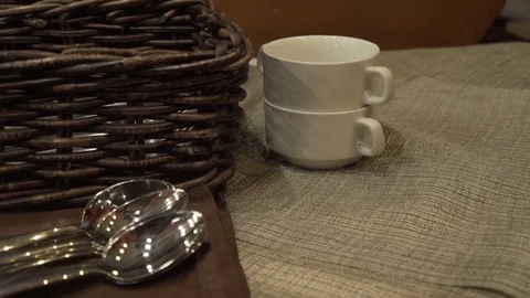 Serving dinnerware dishes soup plates, spoons and bread basket standing on table Stock Footage 83808636