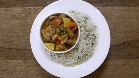 Serving a dish of beef mixed with vegetables and rice, mediterranean food Stock Footage 135421254