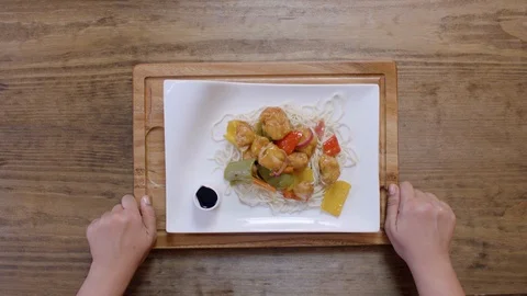 Serving a dish of chicken fillet, vegetables, and noodles Video stock 122764574