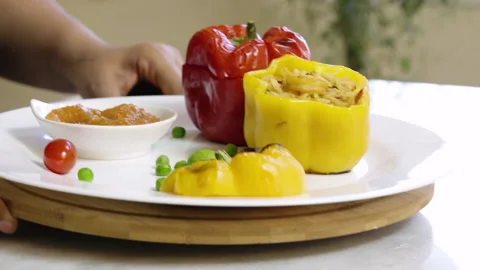 Serving a dish of pepper stuffed with spiced shrimp and rice Stock Footage 134739949