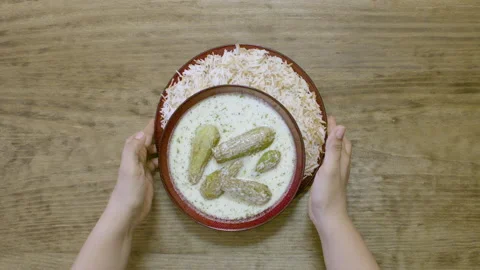 Serving a dish of zuccini stuffed with beef and pine nuts and dipped in yogurt Stock Footage 154225161