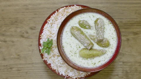 Serving a dish of zuccini stuffed with beef and pine nuts and dipped in yogurt Stock Footage 154227826