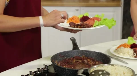 Serving dishes from baked beans and fresh vegetables Video stock 49782216