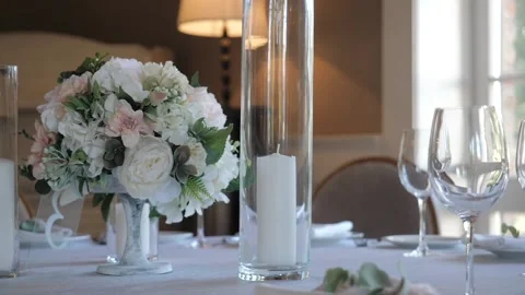 Serving dishes on the table at the wedding Banquet with a floral composition Stock Footage 131009731
