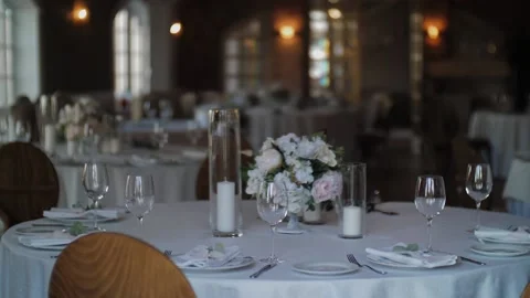 Serving dishes on the table at the wedding Banquet with a floral composition Stock Footage 131009736