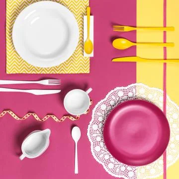 Serving dishes on a yellow pink background.. Stock Photos
