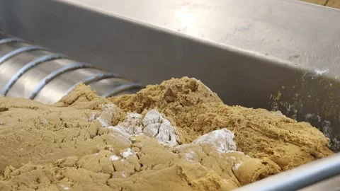 Serving dough for cookie production on the conveyor of a confectionery facto Stock Footage 301771652