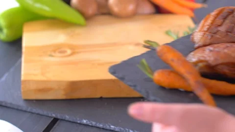 Serving duck breasts with carrots on black stone Stock Footage 110028933