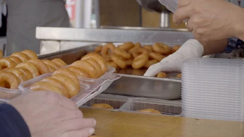 Serving everyone free boxes of Turkish traditional food lokma Stock Footage 99836182