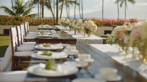Serving exquisite wedding table with beautiful flowers outdoors on resort hyatt Stock Footage 101127003