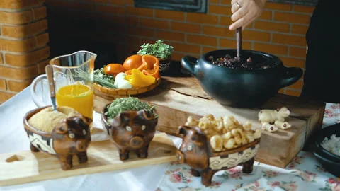 Serving feijoada, a Brazilian dish on a lunch table Video stock 163943013
