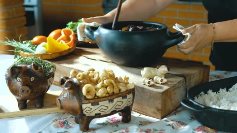 Serving feijoada, a Brazilian dish on a lunch table Stock Footage 163944058
