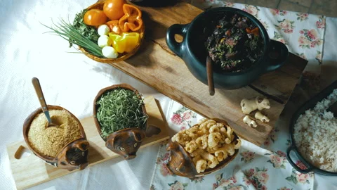 Serving feijoada, a Brazilian dish on a lunch table Stock Footage 163944437