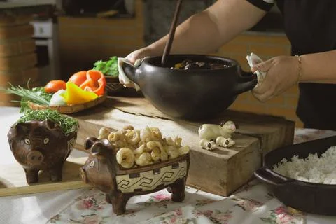 Serving feijoada, a Brazilian dish on a lunch table Stock Photos