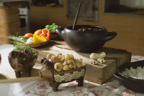 Serving feijoada, a Brazilian dish on a lunch table Stock Photos