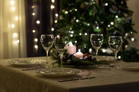 Serving the festive table. Food and drinks, plates and glasses. Evening light Stock Photos