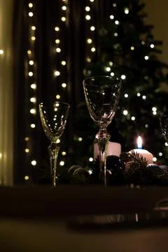 Serving the festive table. Food and drinks, plates and glasses. Evening light Stock Photos