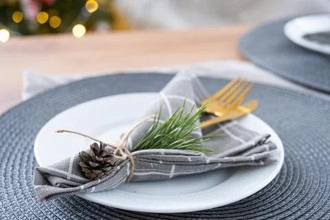 Serving festive table with plates, forks, knives, napkins for Christmas Foto stock