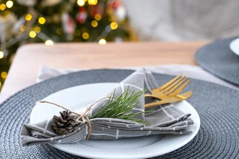 Serving festive table with plates, forks, knives, napkins for Christmas Foto stock