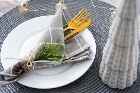 Serving festive table with plates, forks, knives, napkins for Christmas Foto stock