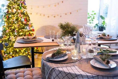 Serving a festive table with plates, forks, knives, napkins, glasses close-.. 写真素材