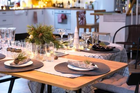 Serving a festive table with plates, forks, knives, napkins, glasses close-.. Stock Photos