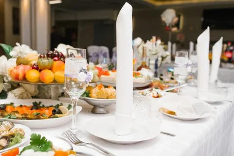 Serving a festive wedding Banquet table. A white napkin is on the plate Stock Photos