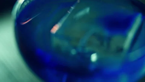 Serving the finished cocktail on ice with blue syrup Stock Footage 196981980