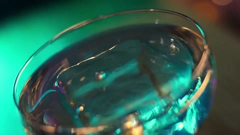 Serving the finished cocktail on ice with blue syrup, close-up Stock Footage 196981986